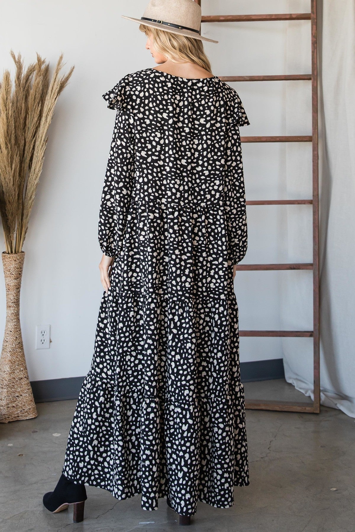 Bohemian maxi dress back view in black with white irregular heart print and tiered skirt