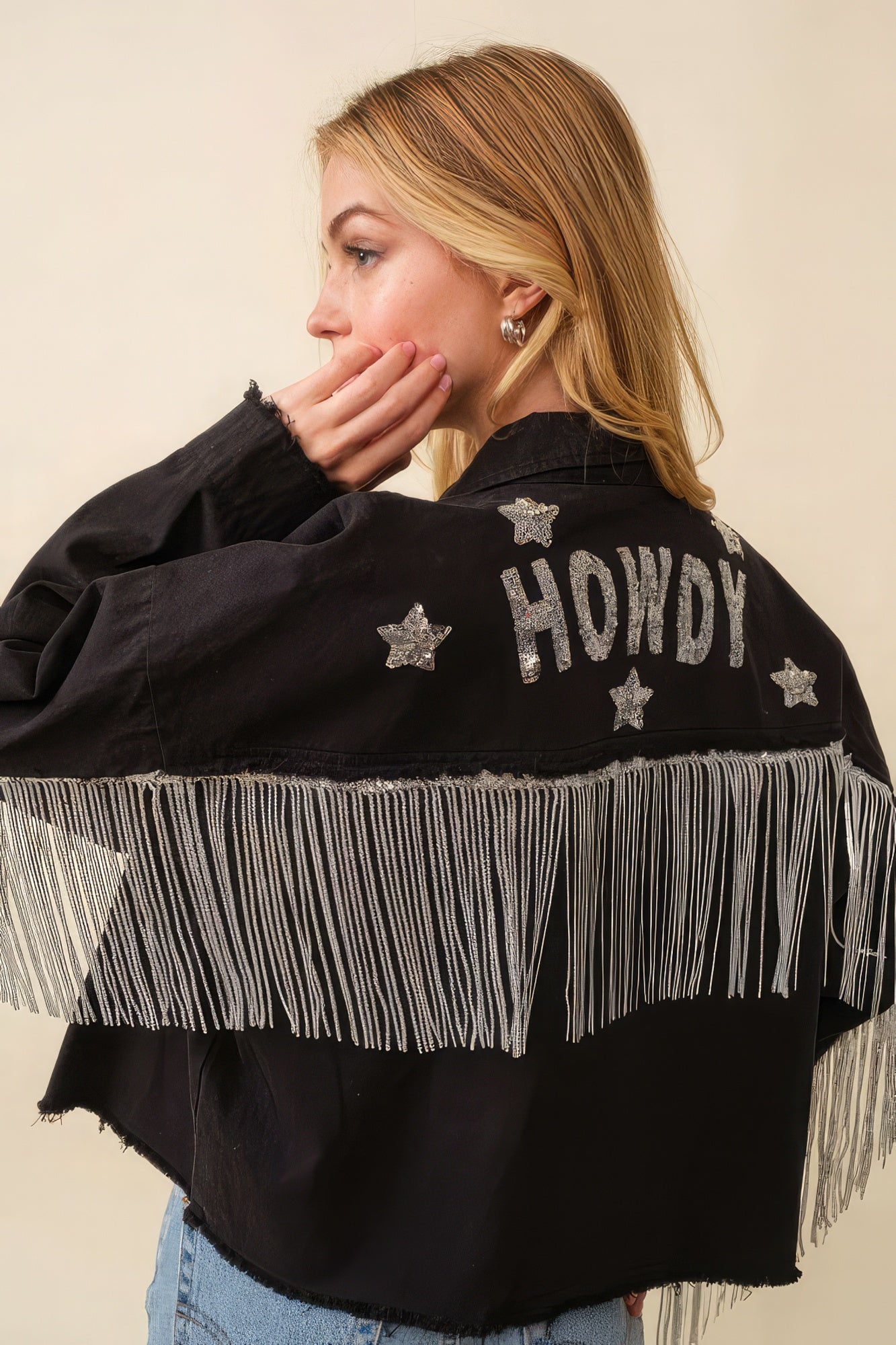Black Howdy jacket back with “Howdy” text, star appliqués, and long fringe trim