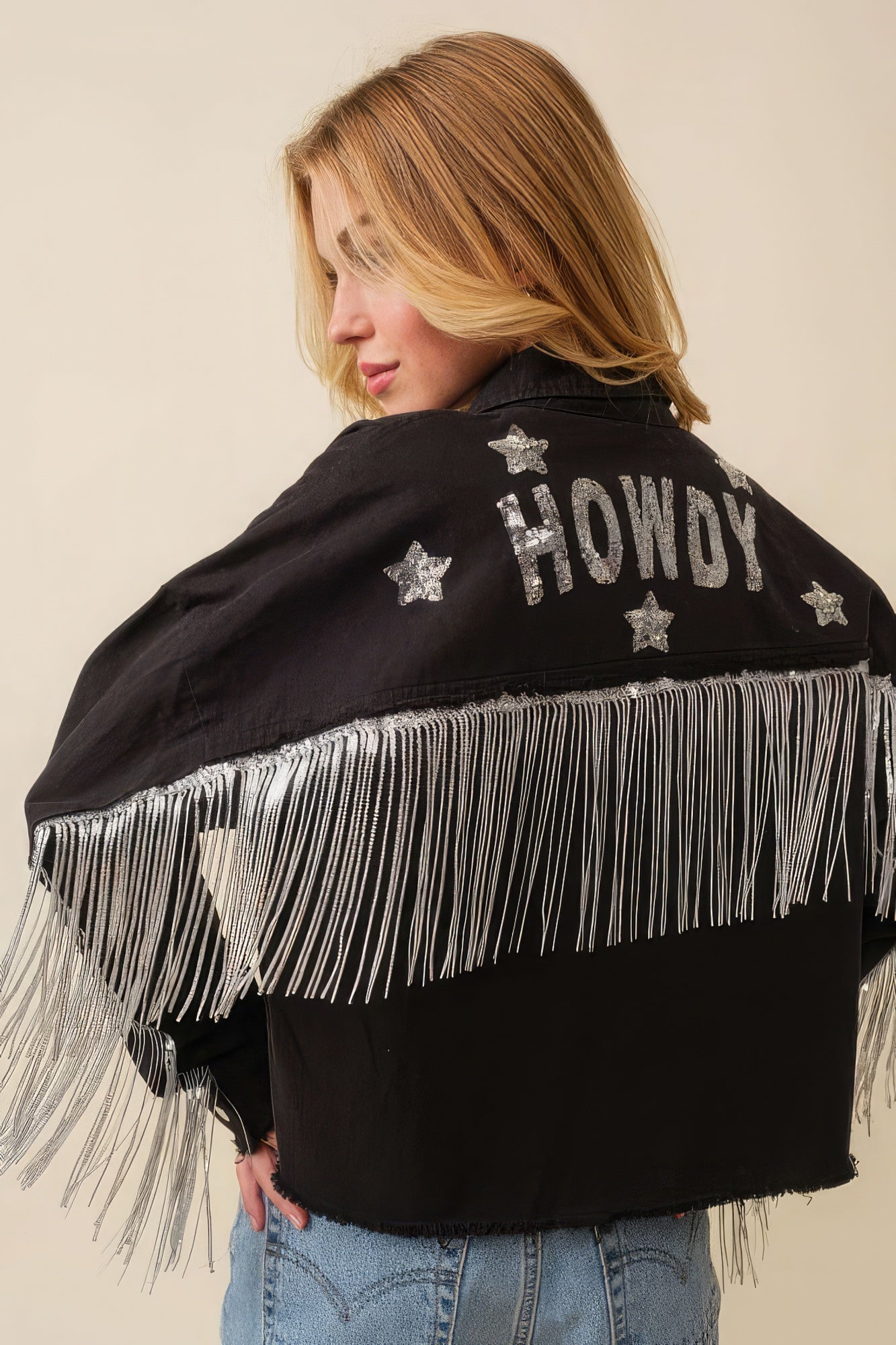 Black Howdy jacket with “Howdy” and star patches, silver fringe hem and collar