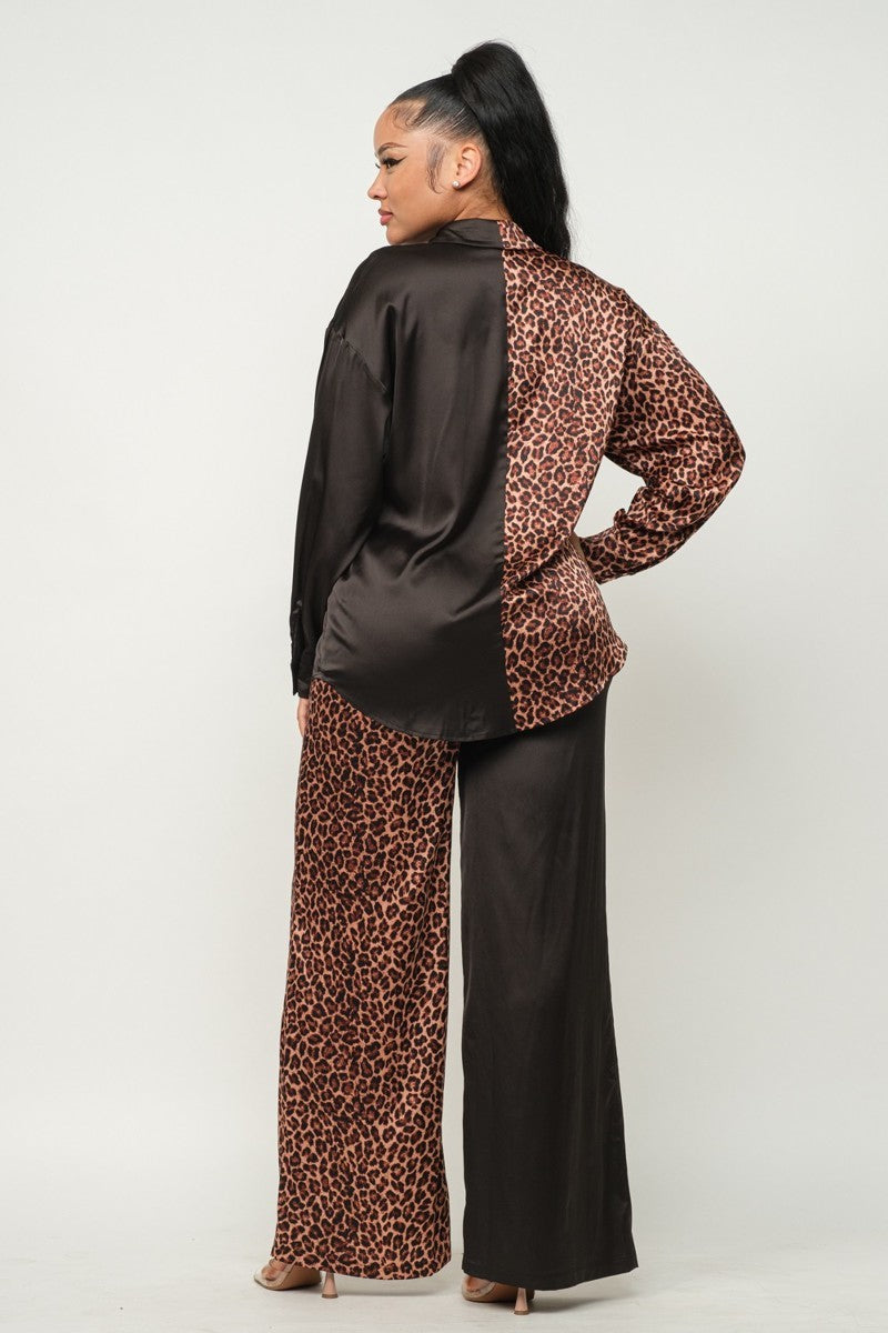 Back view: solid black blouse with leopard-print sleeves and matching wide-leg pants
