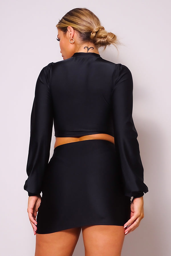 Back view: black long-sleeve turtleneck blouse with ruched mini skirt in one set