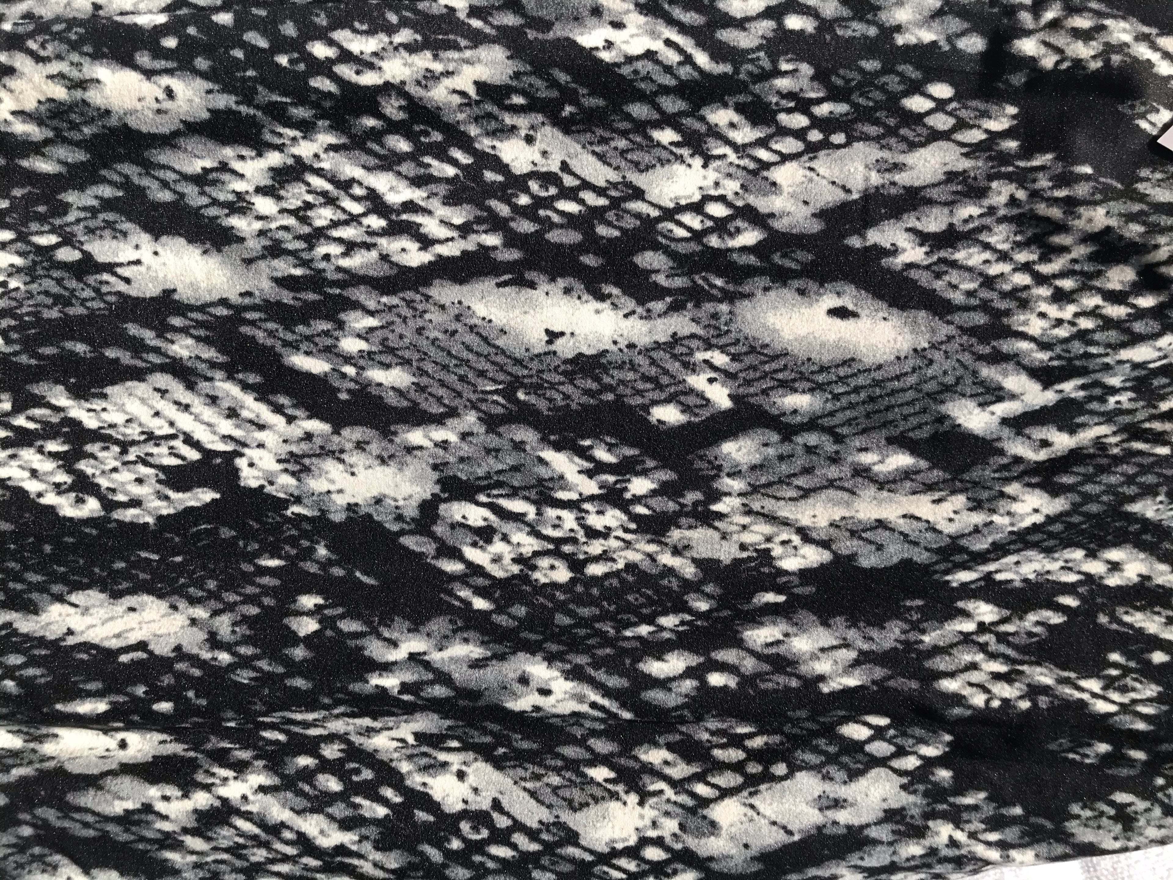 Snake-print fabric texture, black multicolor with mottled light-gray pattern