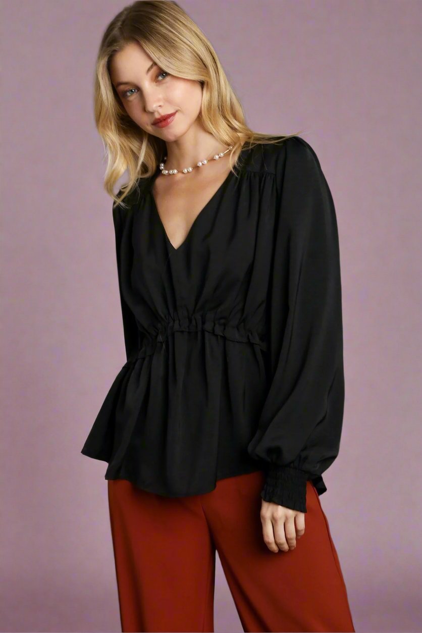 Black satin V-neck baby doll top with long puff sleeves, elastic cuffs, and gathered waist