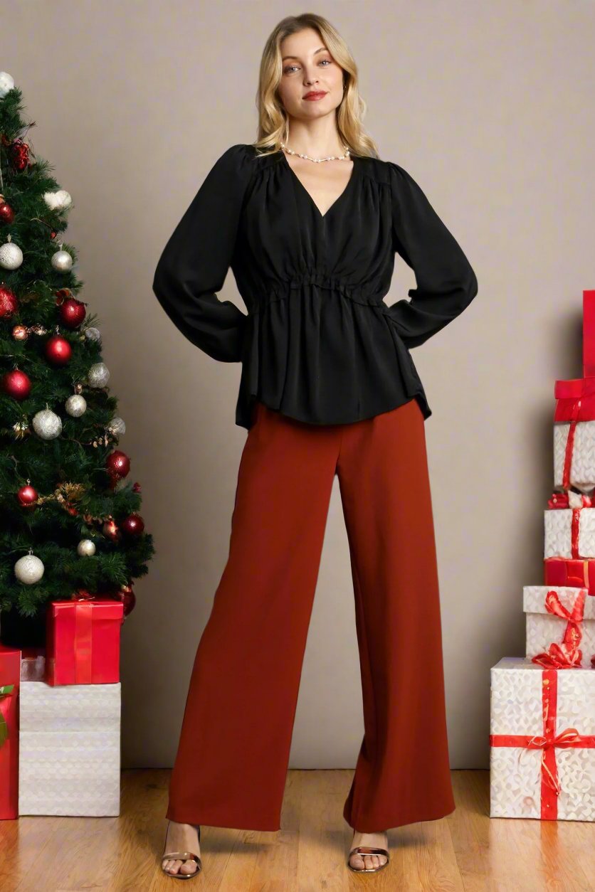 Black satin V-neck baby doll top with ruffled peplum hem and cuffed long sleeves