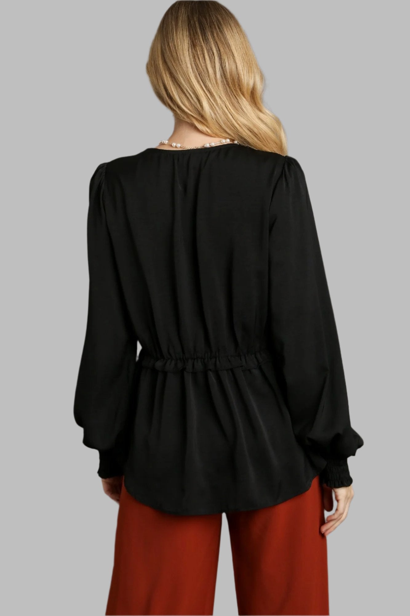 Black satin baby doll top back view with gathered waist and long puff sleeves