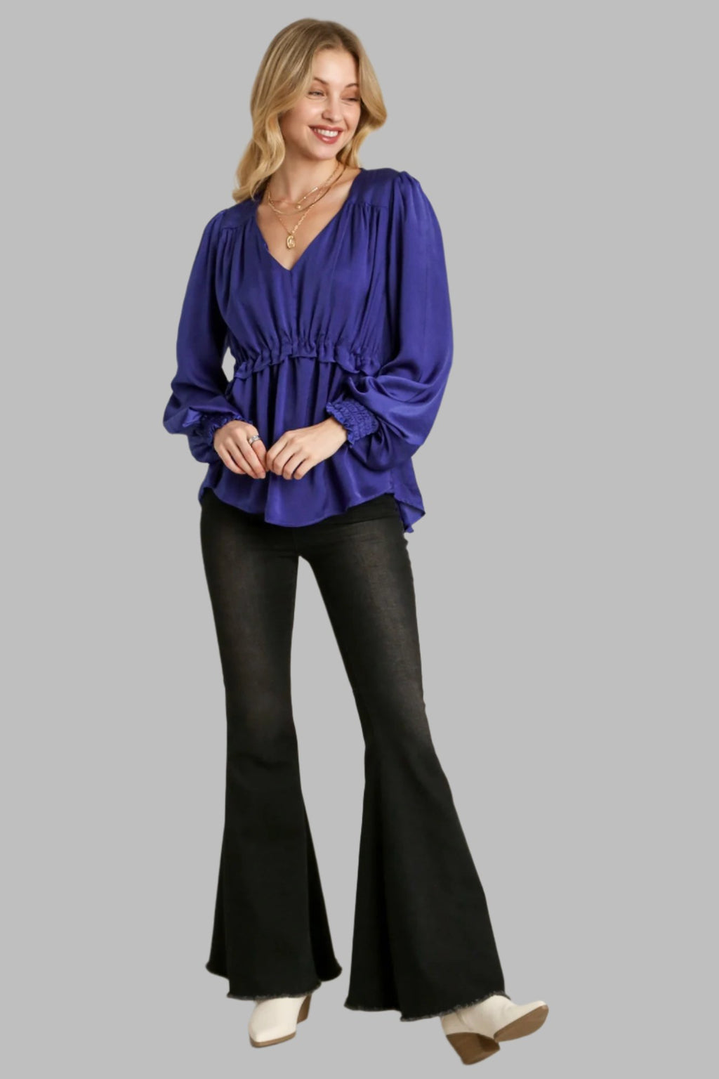 Blue satin baby doll top with ruched waist, long puff sleeves, and V-neck