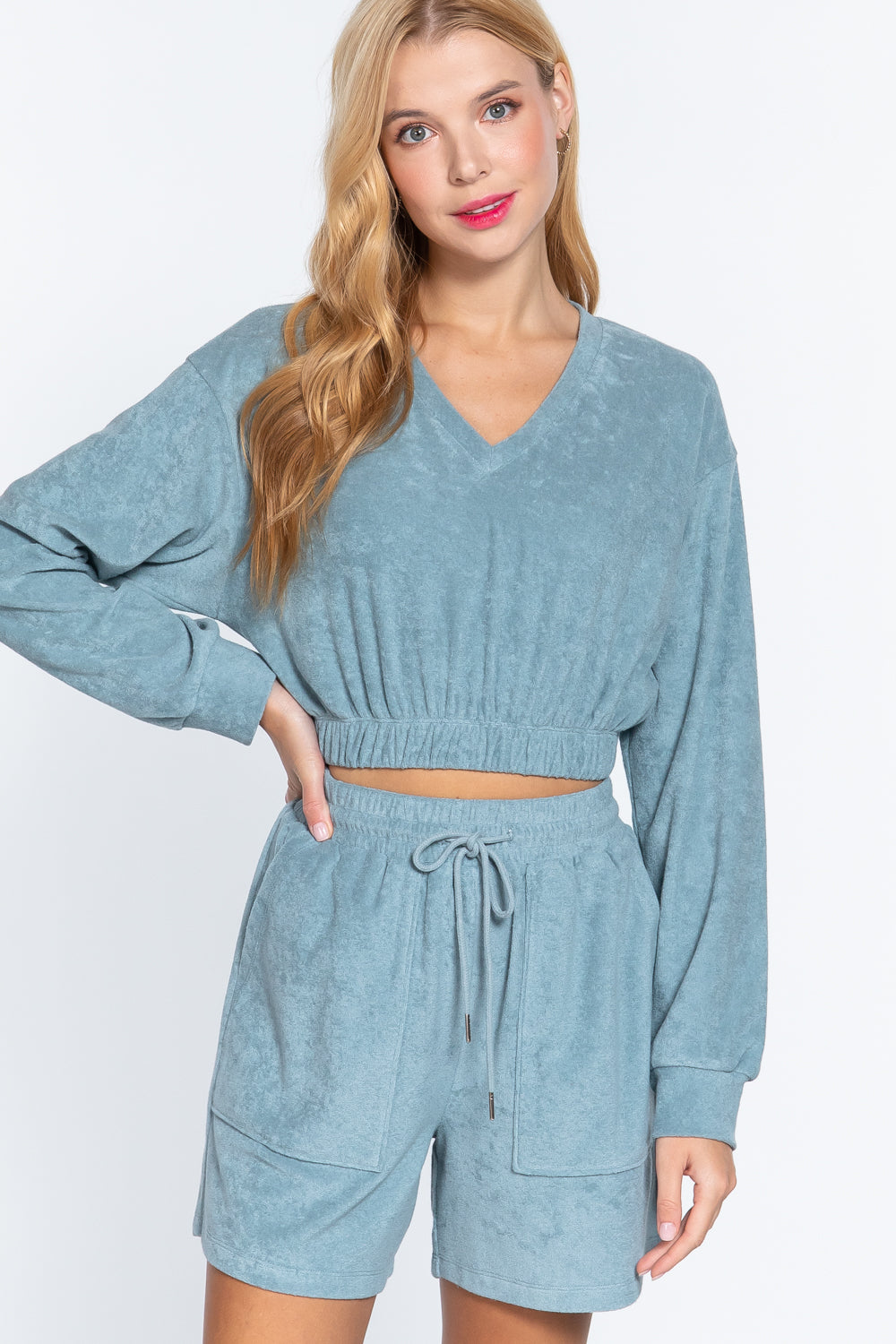 Terry toweling top in stone blue, V-neck, elastic waist hem, long sleeves