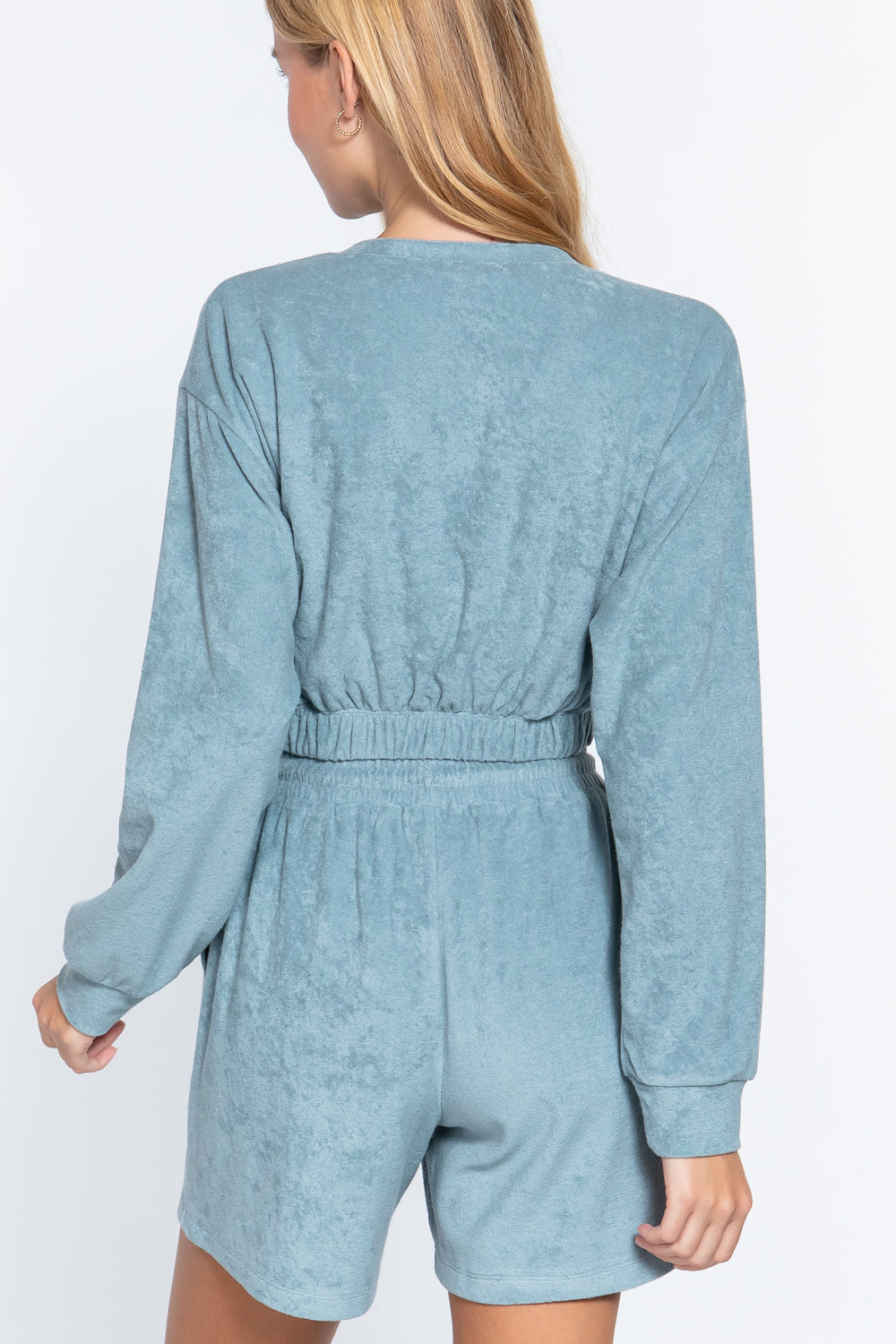 Stone blue terry toweling top back view, gathered elastic waist hem, long sleeves