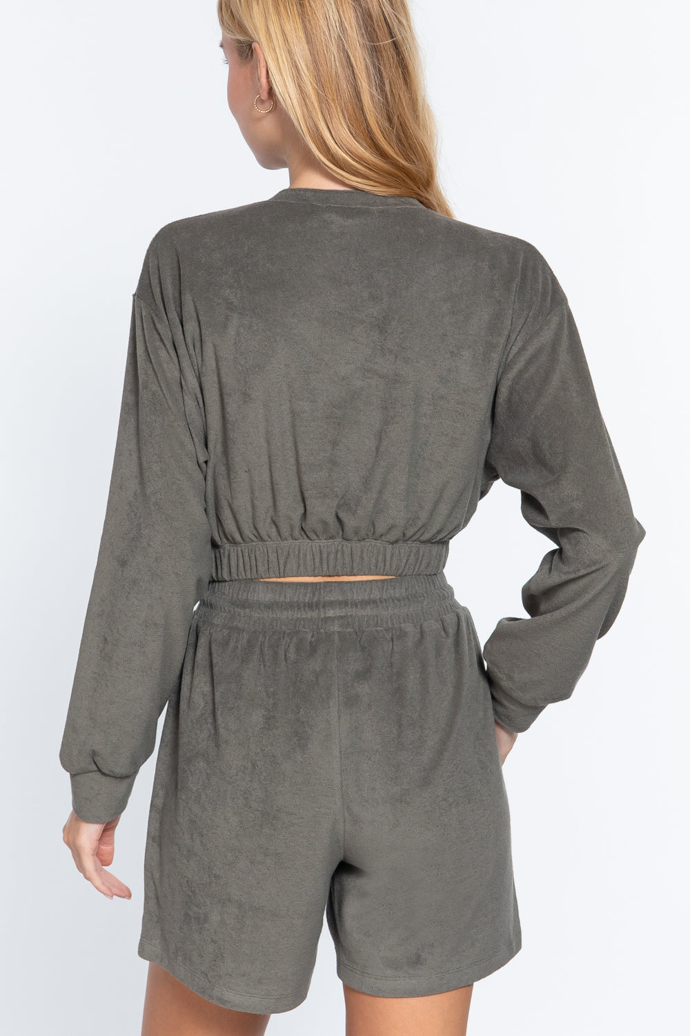 Back view: Olive terry toweling top with elastic hem and gathered waist, long sleeves