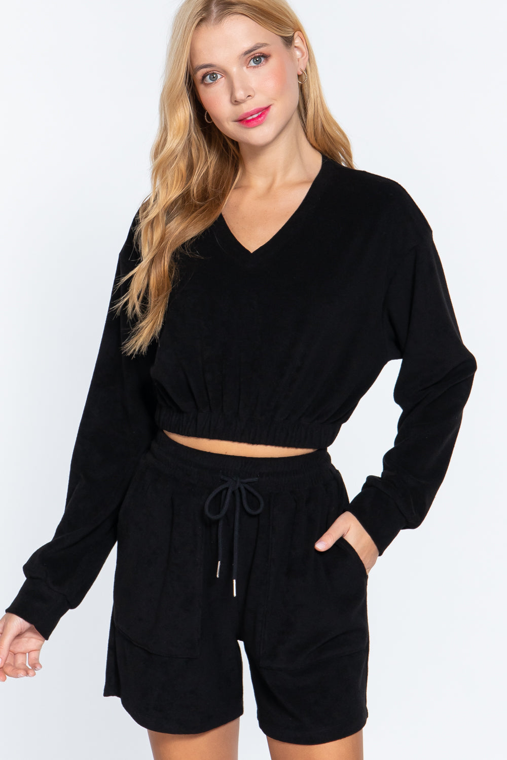 Black terry toweling top with elastic hem, long sleeves, V-neck, drawstring waist