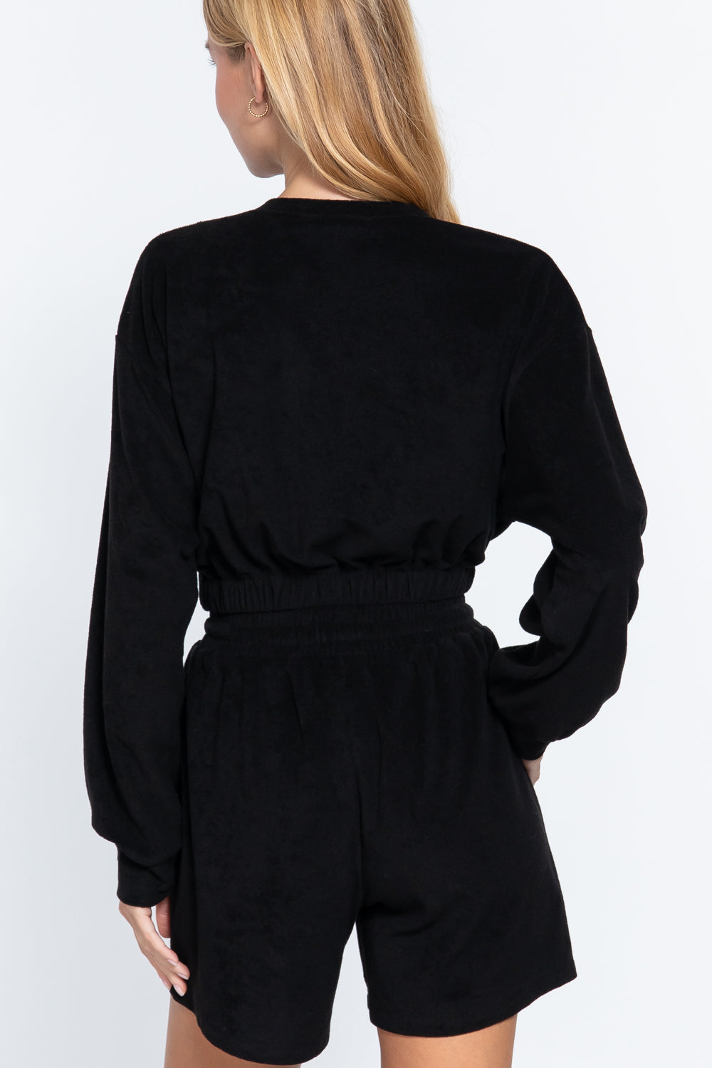 Black terry toweling top with elastic hem, long sleeves, gathered waistband (back view)
