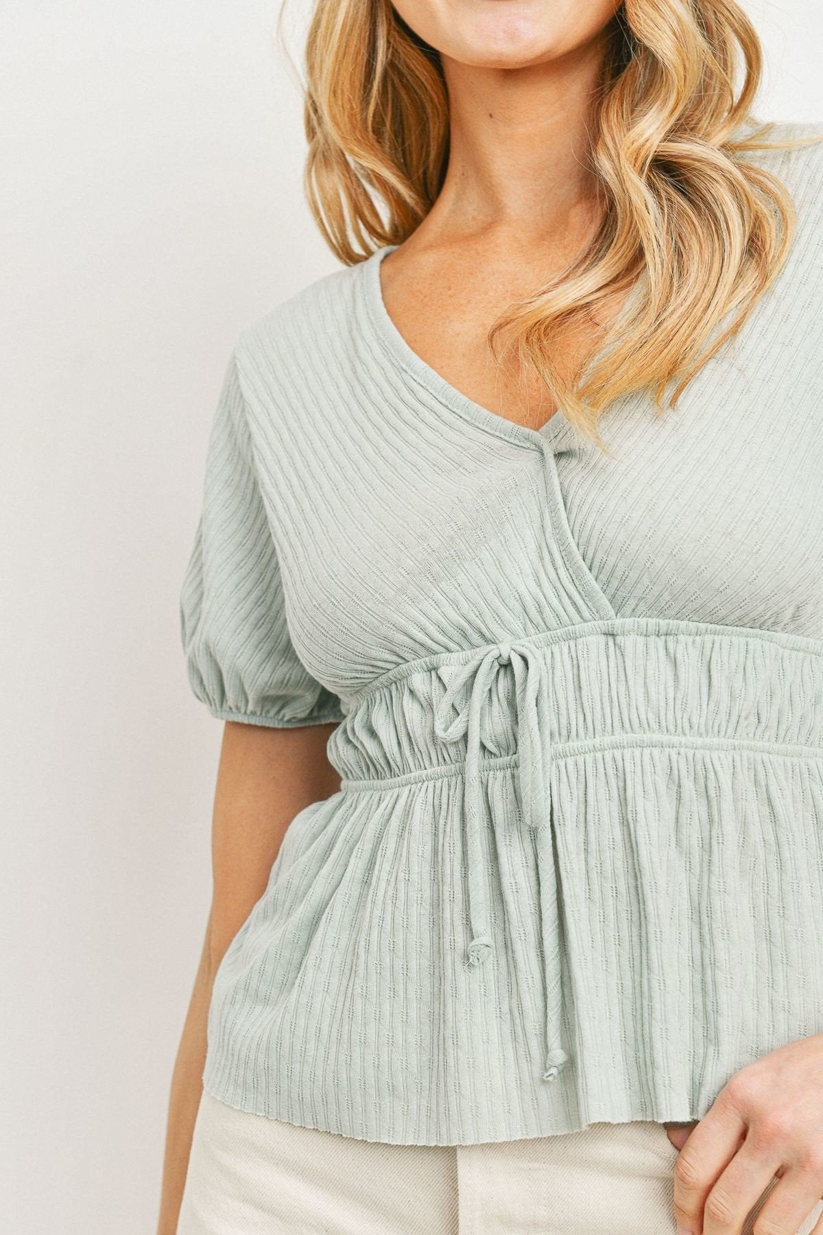 Mint waist-tie peplum top with puff sleeves and gathered front