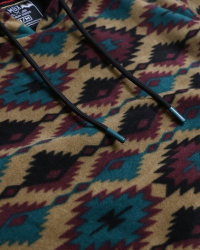 Close-up of drawstring hood and colorful Aztec diamond pattern