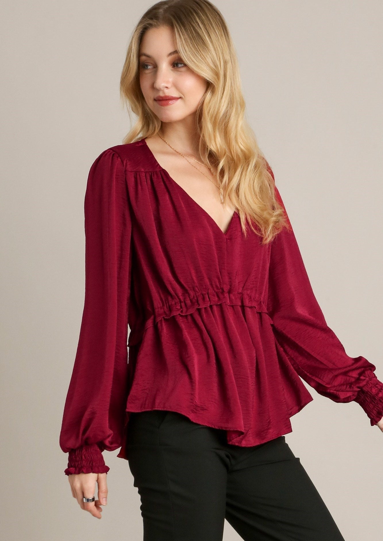 Red V-neck baby doll top with gathered waist and long puff sleeves, elastic cuffs