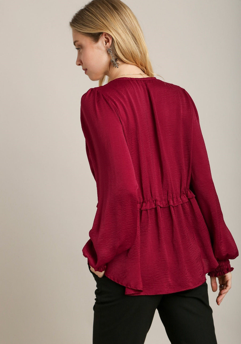 Back view: red baby doll top with gathered yoke and elastic cuff long sleeves