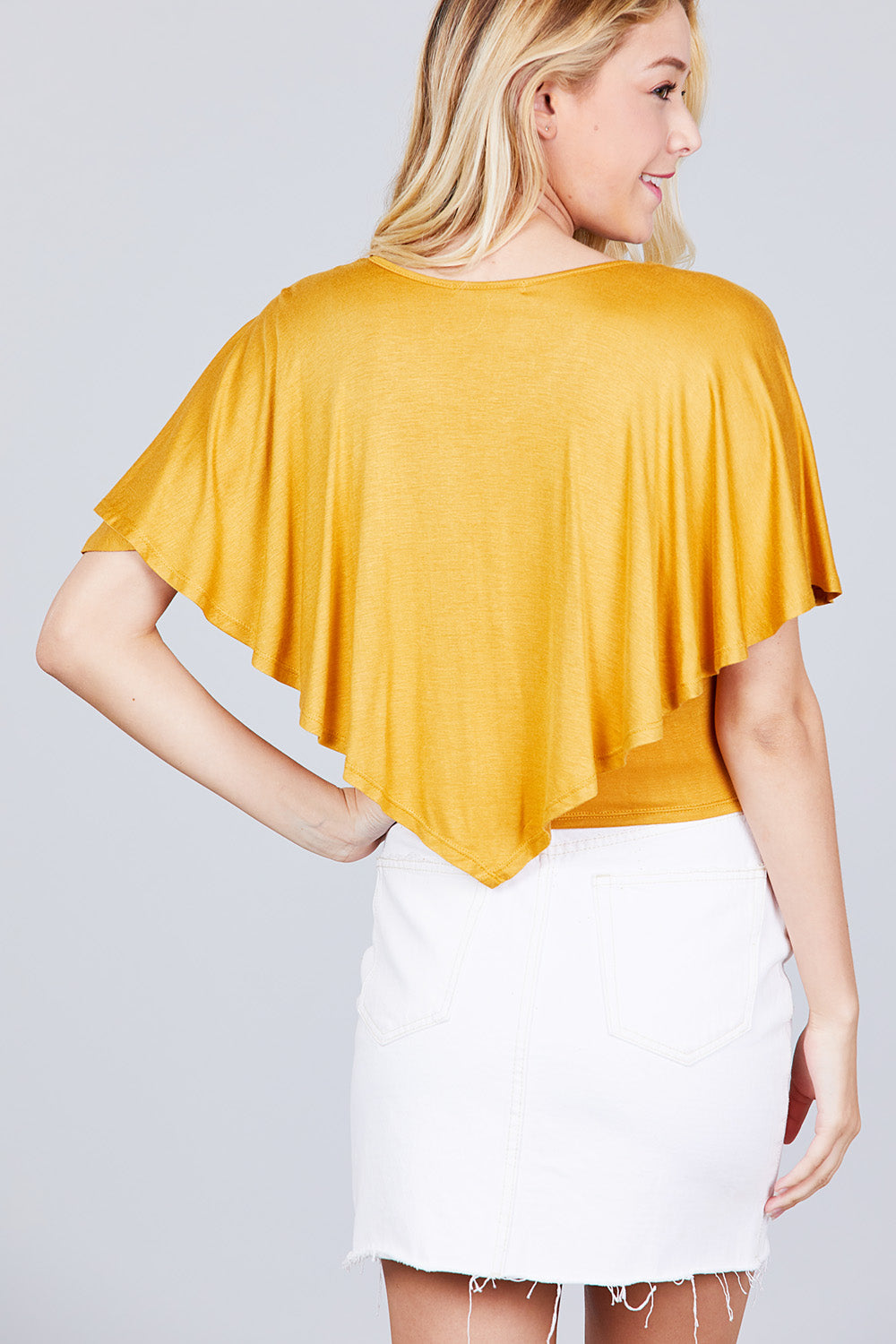 Back view: dark mustard V-neck flounce cape top with draped short ruffle sleeves