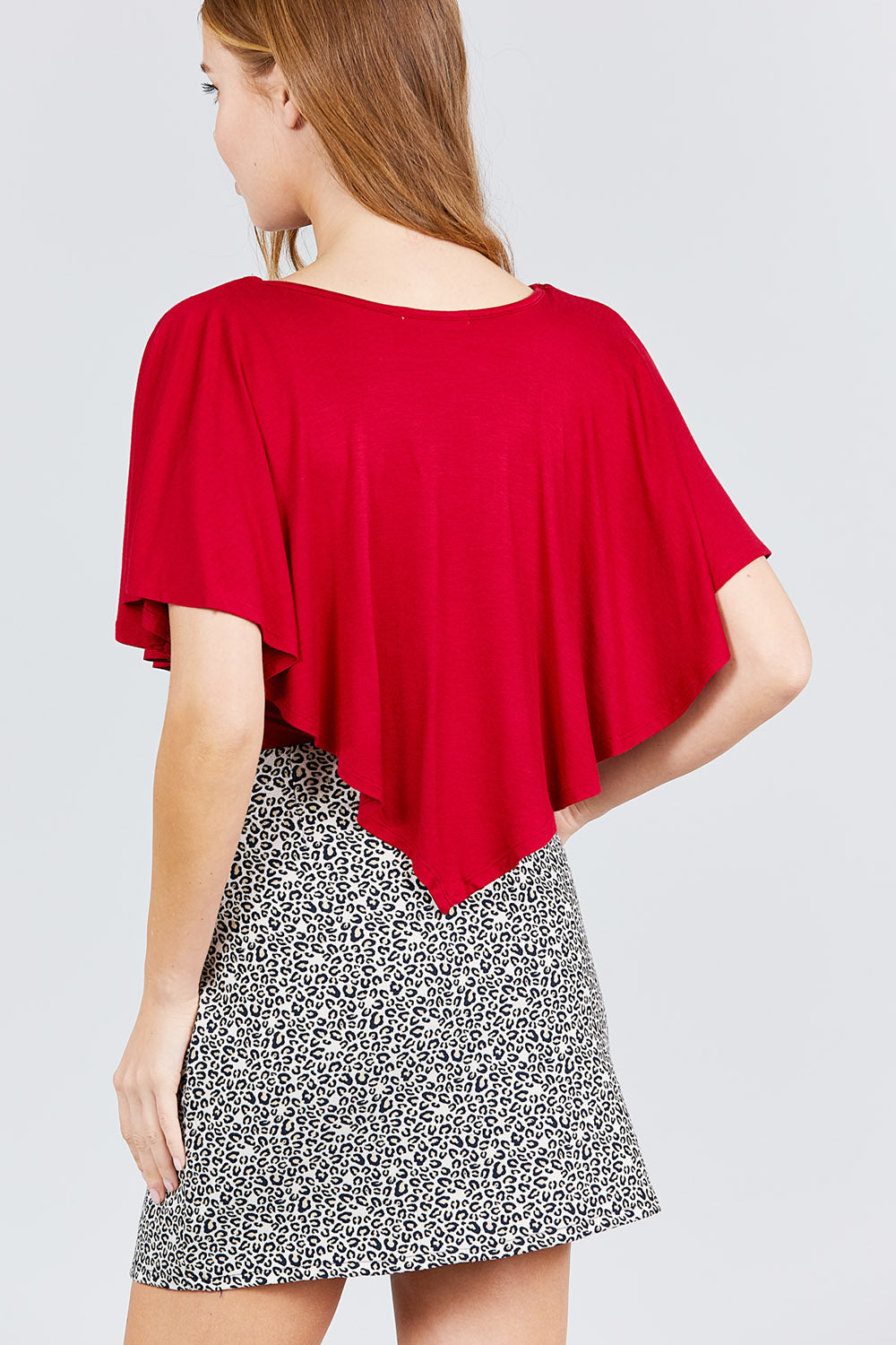 Back view: chili red V-neck flounce top with flowing short flutter sleeves.