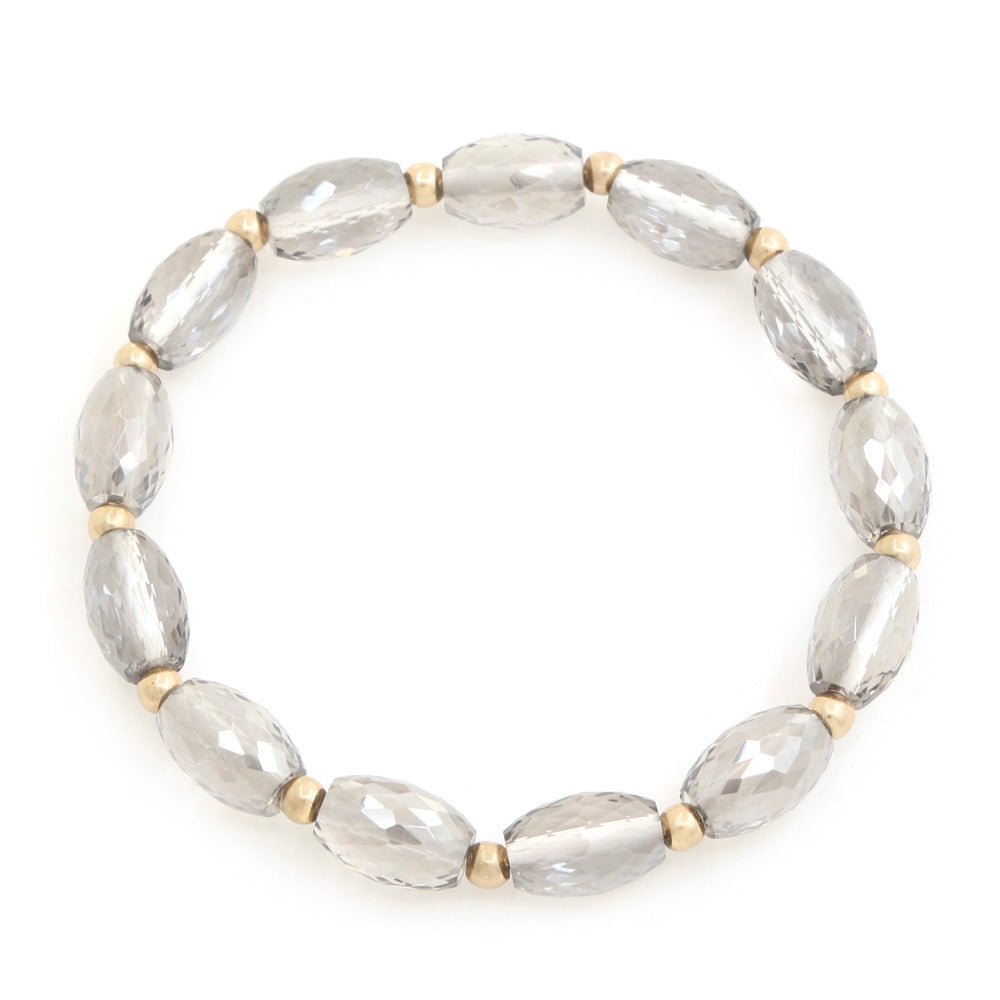 Beaded bracelet with gray faceted oval beads and gold-tone spacers