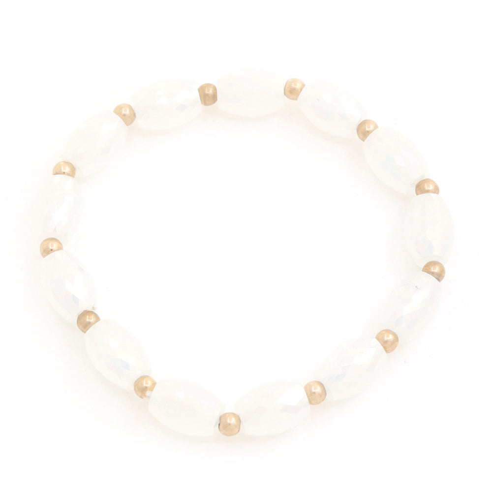Beaded bracelet with ivory faceted oval beads and gold-tone spacers