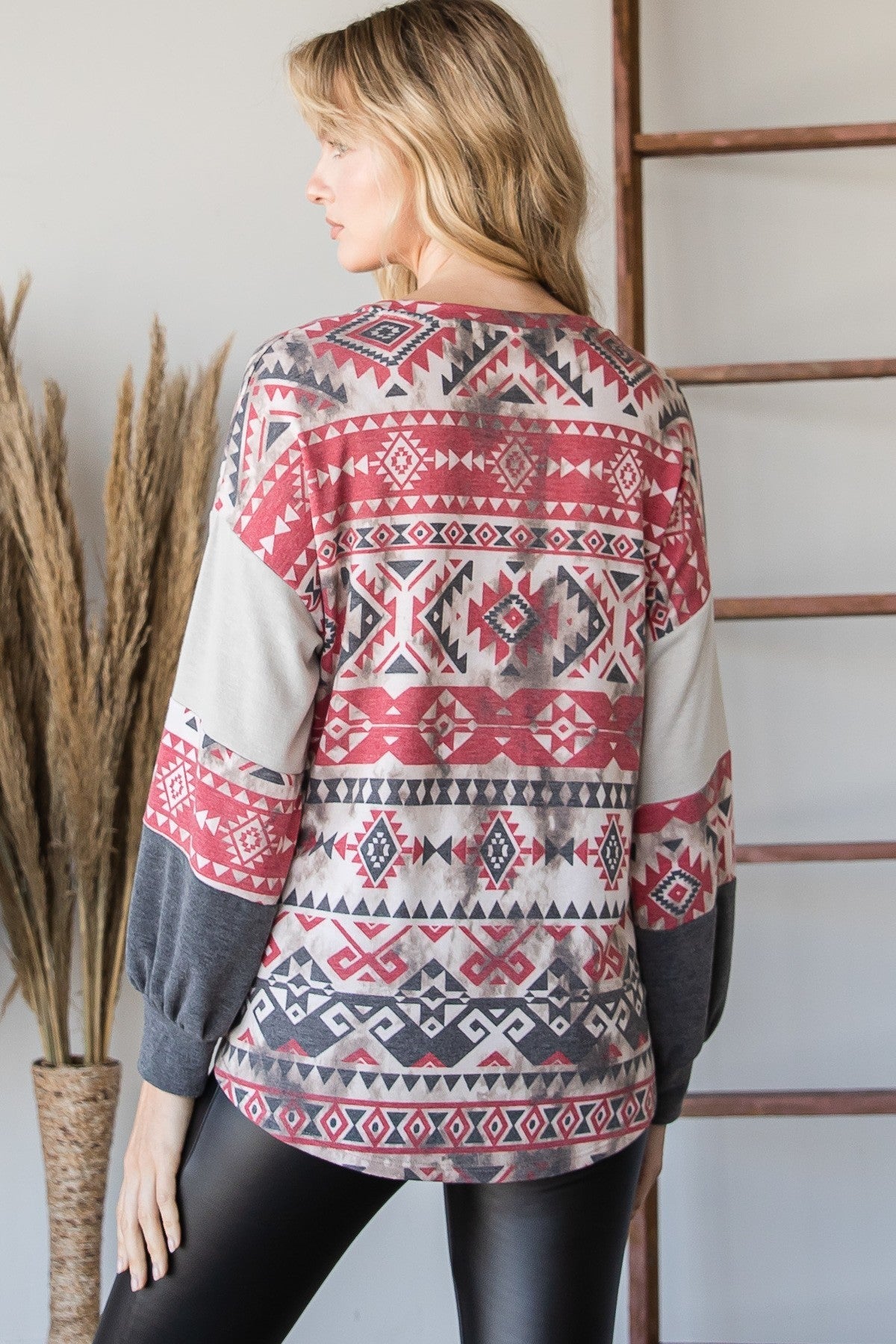 Aztec print long-sleeve sweater, back view with red geometric banding and gray sleeves