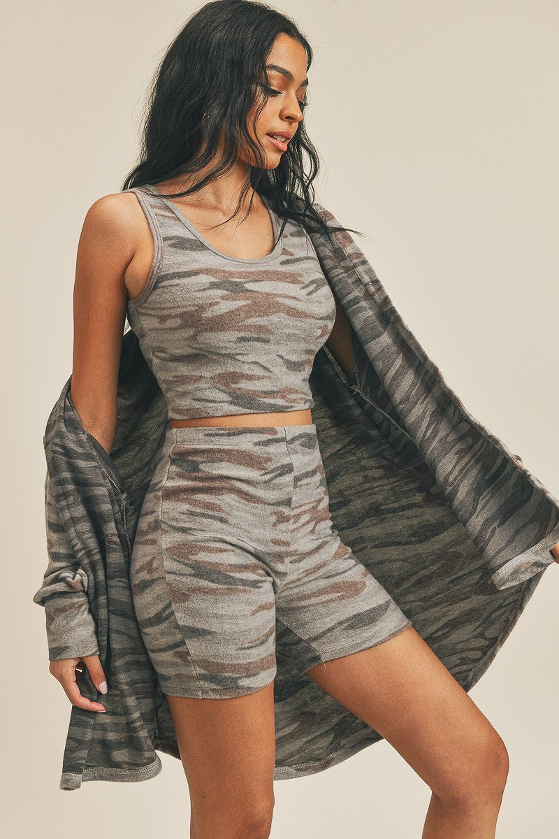 Camo cardigan draped over matching shorts and sleeveless crop tank top