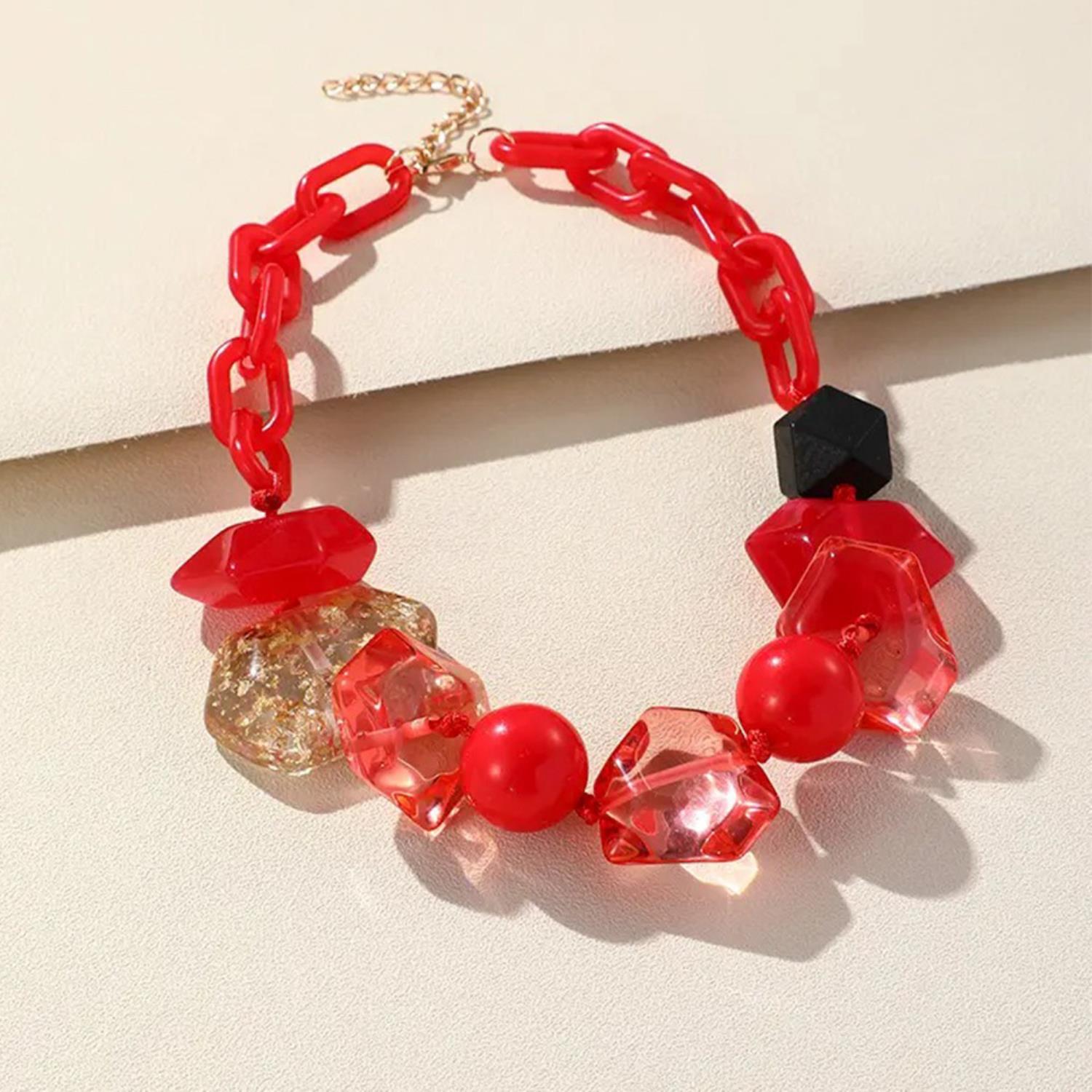 Red chunky beaded oval link necklace with faceted beads, black cube accent and gold clasp