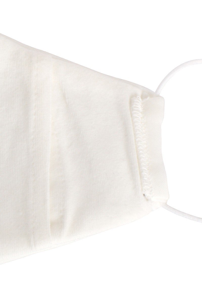 White reusable face mask fabric close-up with elastic ear strap