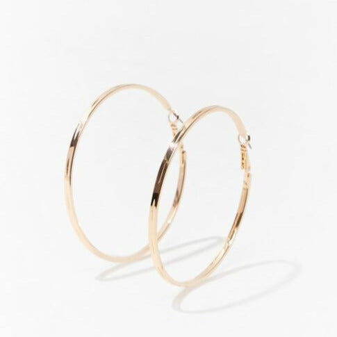 Gold hoop earrings with etched texture, angled close-up, 2.5 in
