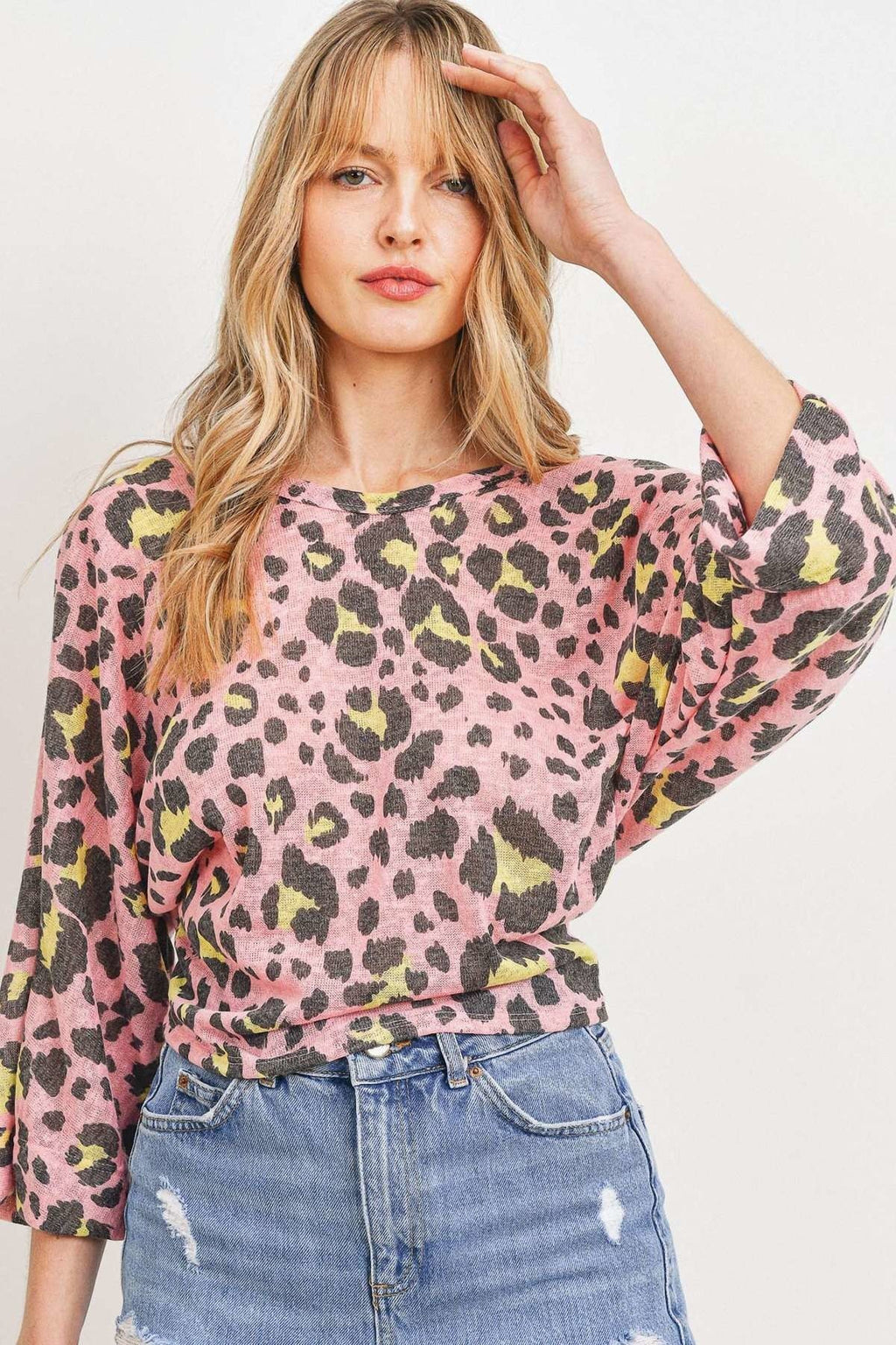 Pink leopard print knit top, crew neckline, three-quarter sleeves, relaxed fit