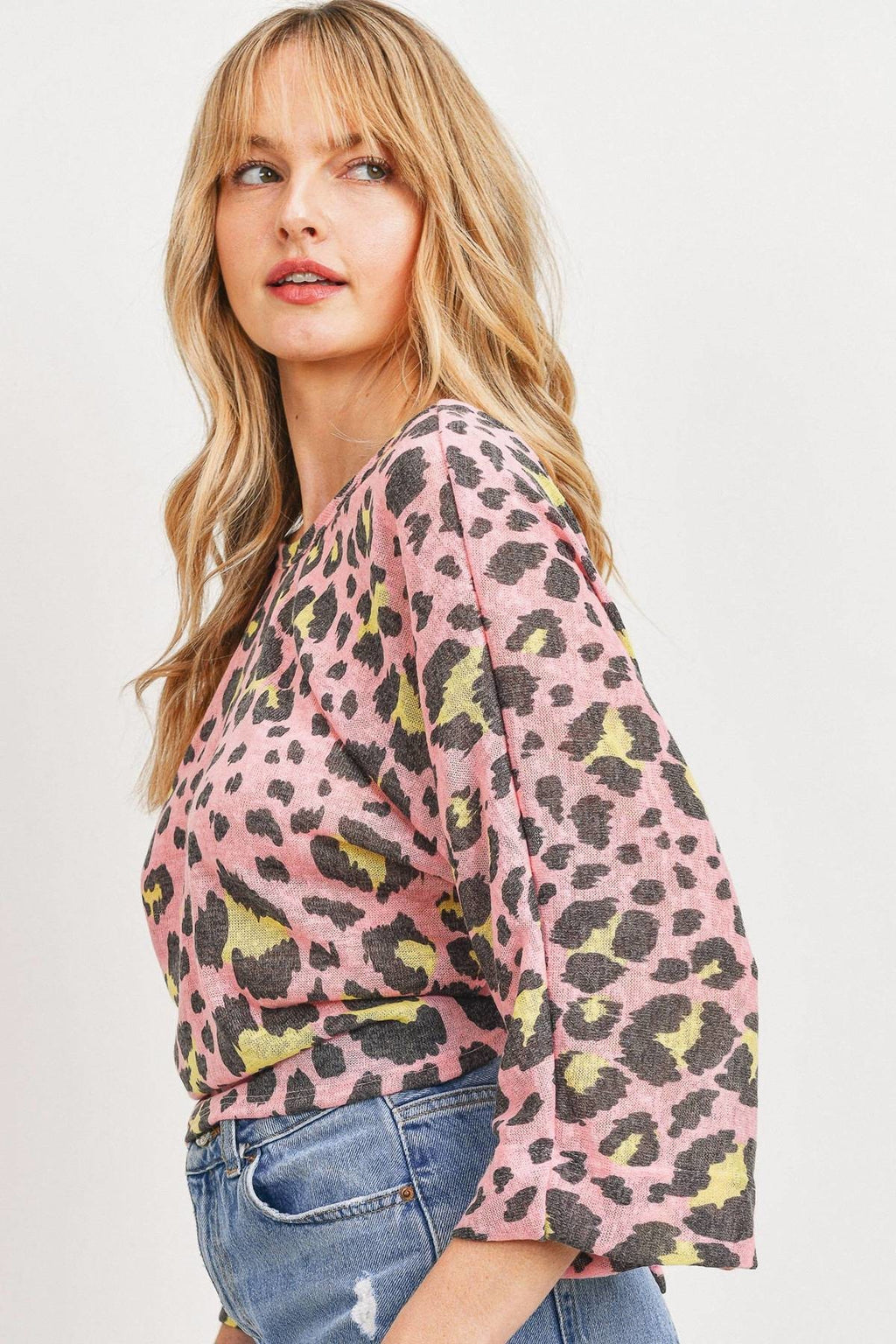 Pink leopard print knit top, side view, three-quarter sleeves and crew neckline