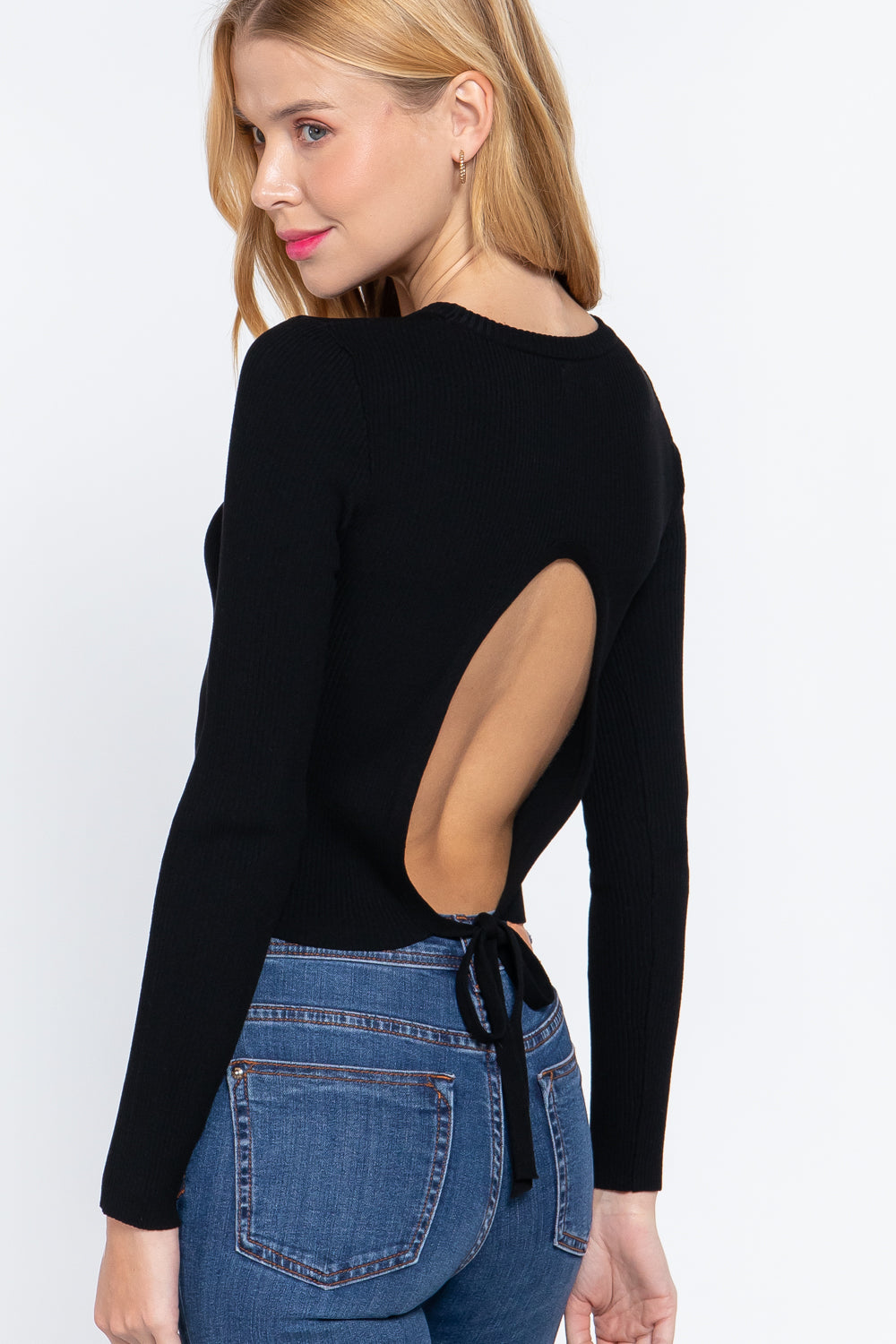 Black sweater top with long sleeves and open back cutout