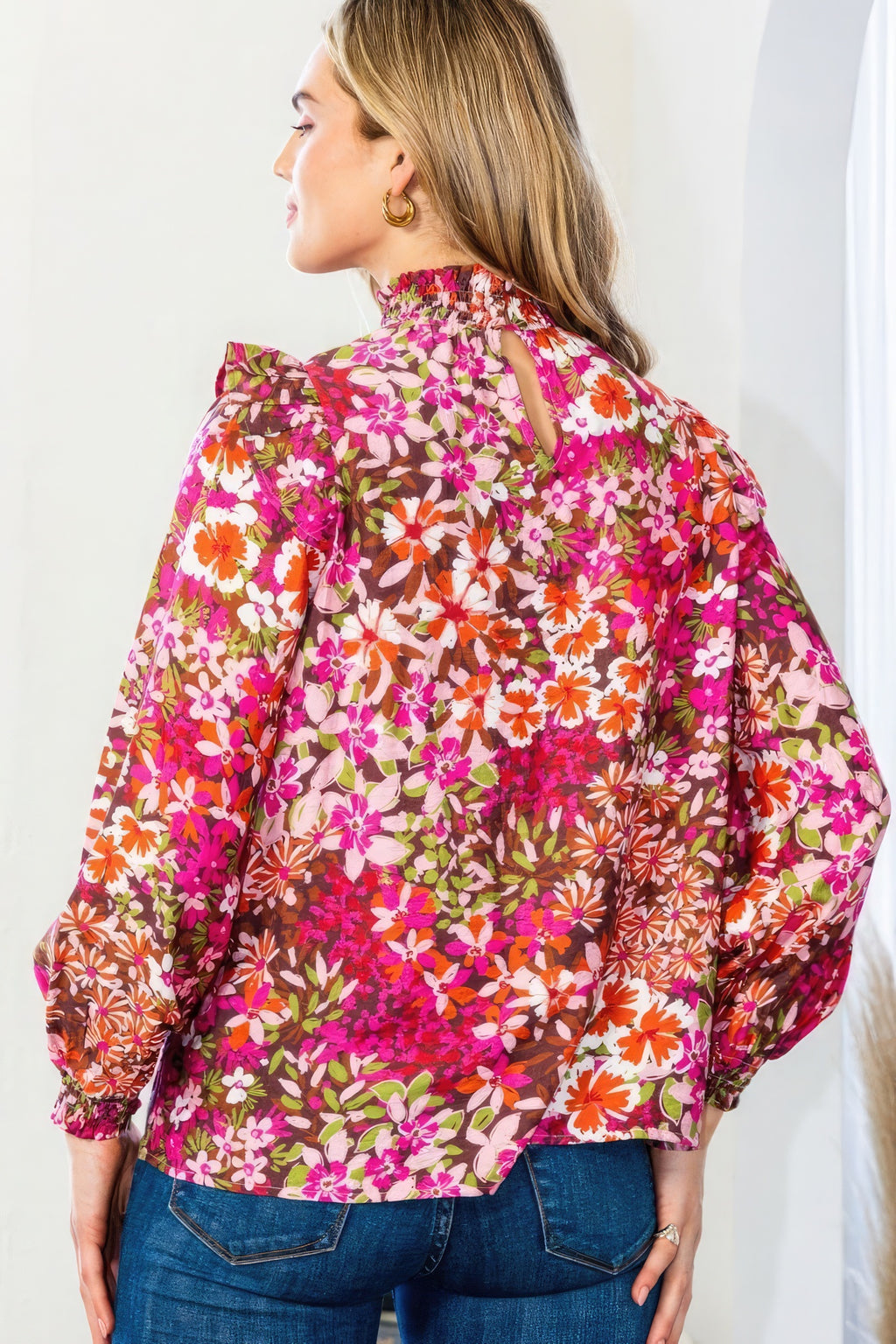 Dark pink floral blouse back view with mock neck and long puff sleeves