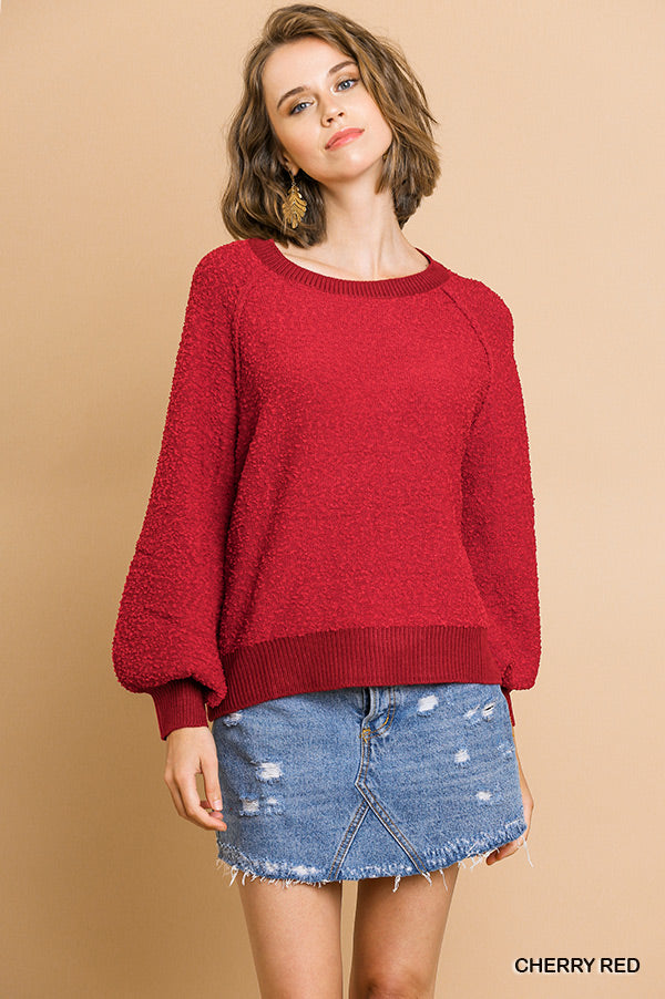 Cherry red puff-sleeve boat-neck sweater, textured knit top with loose fit.