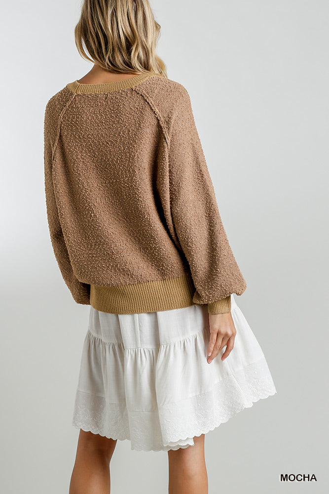 Mocha puff-sleeve boat-neck sweater, back view with rounded knit hem and roomy fit.