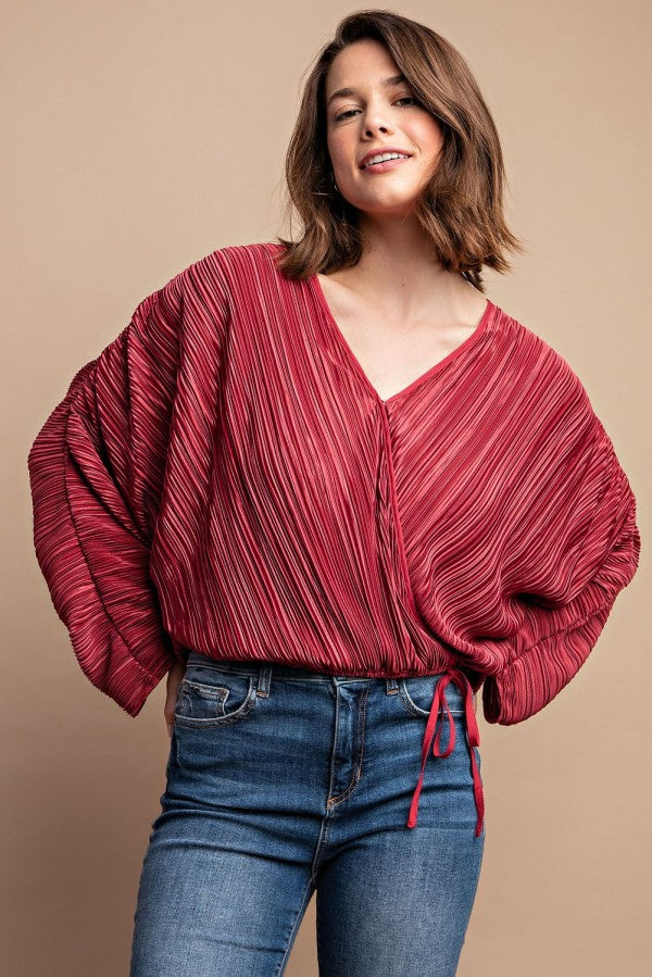 Burgundy pleated V-neck blouse with snap front and gathered drawstring waist