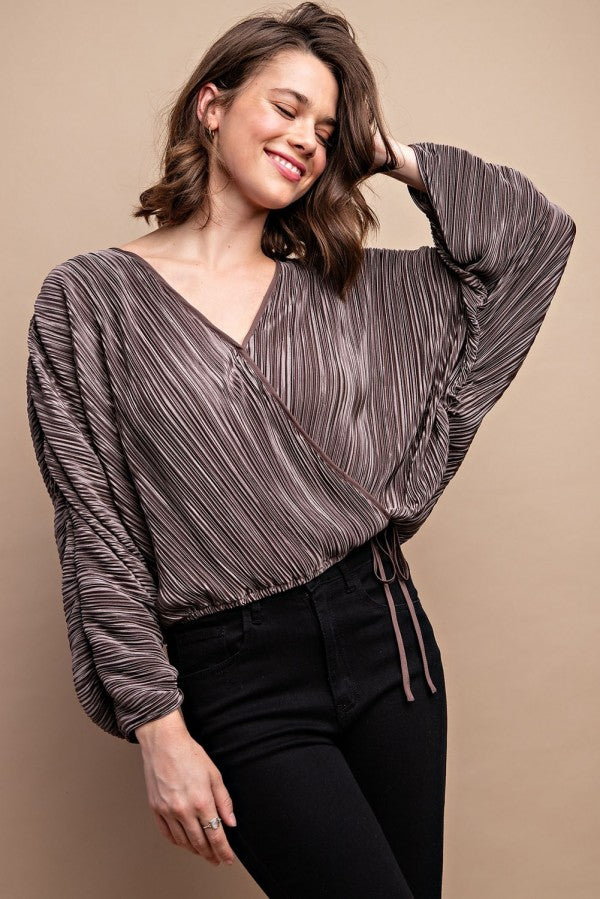 Silvery pleated V-neck satin top, long sleeves, draped neckline with snap front