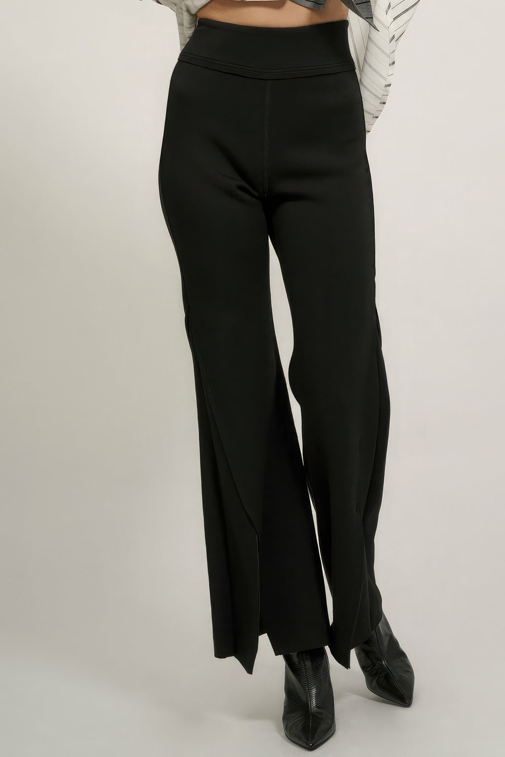 Black flare pants with exposed seam detail and raw hem, high waist