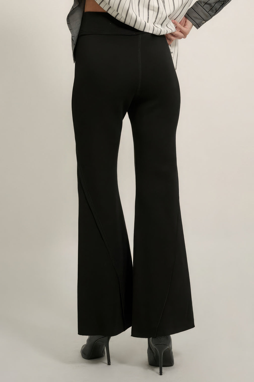 Black wide-leg flare pants with sleek front crease and raw-edge hem