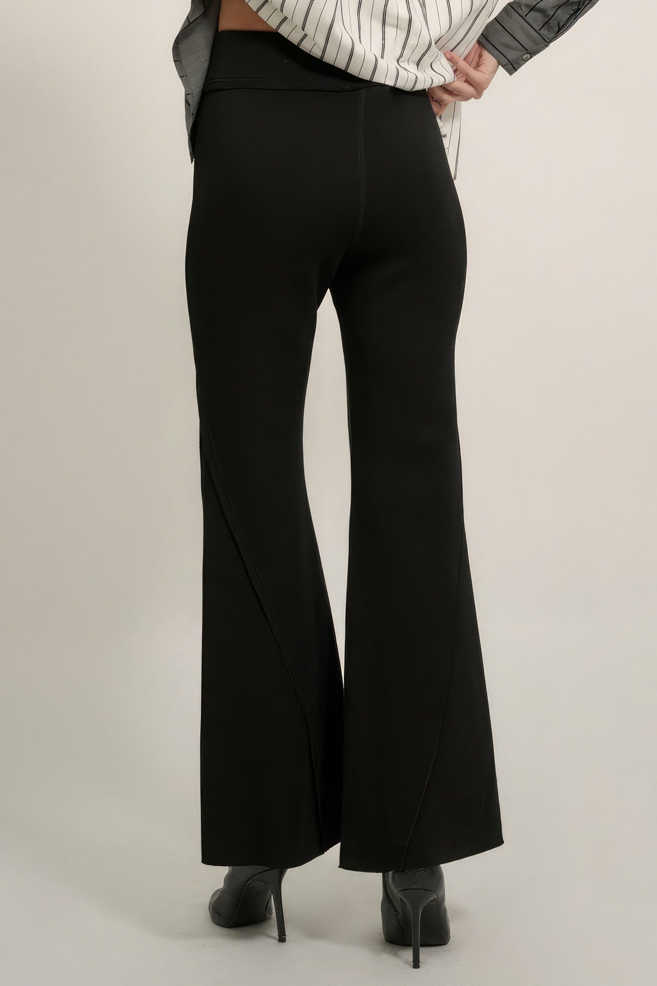Black wide-leg flare pants with sleek front crease and raw-edge hem