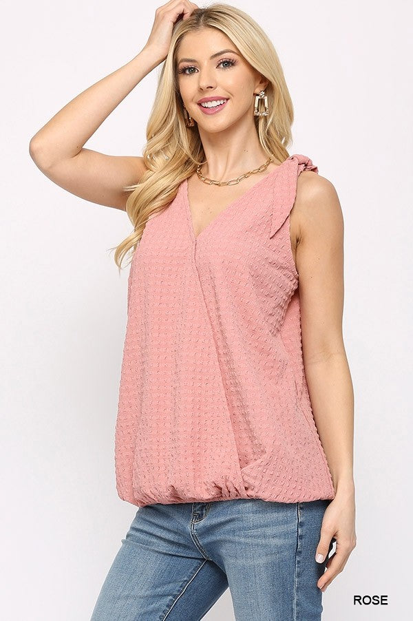 Rose surplice sleeveless top with shoulder tie detail and textured V-neck front
