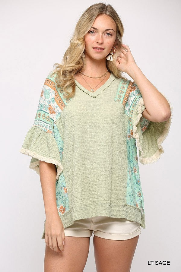 Light Sage knit top with printed sleeves, V-neck and hi-low hem