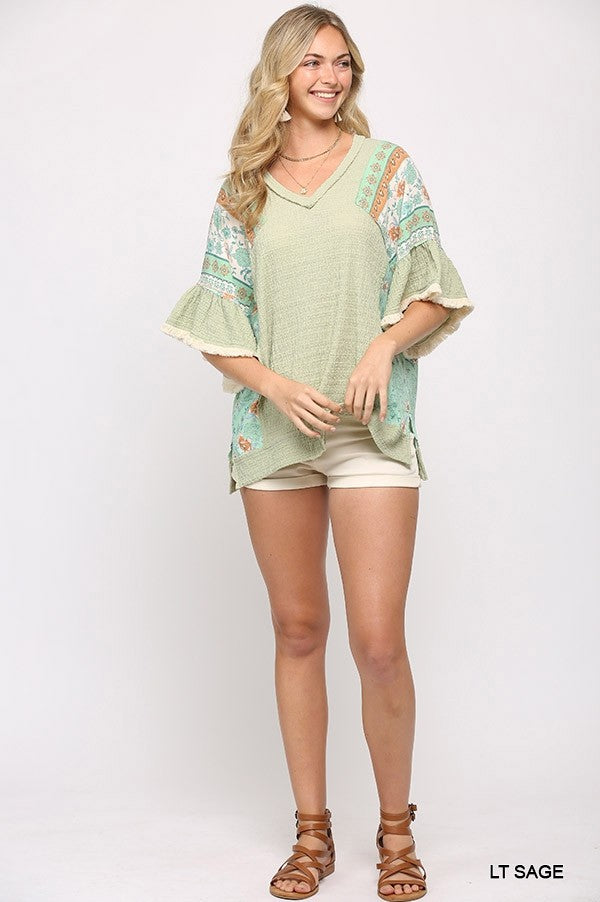 Light Sage hi-low hem mixed texture knit top with patterned flutter sleeves