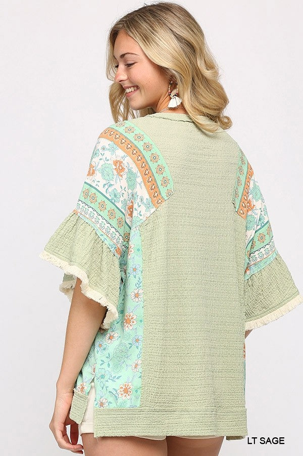 Light Sage back view of mixed knit top with printed sleeves and scalloped hem